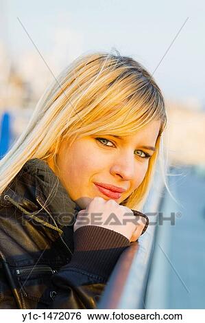 Attractive young woman face close-up in late afternoon sun View Large Photo Image Stock Photograph - Attractive young woman face close-up in late afternoon sun. Fotosearch