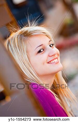 Stock Image - Attractive young woman happy and smiling portrait. Fotosearch