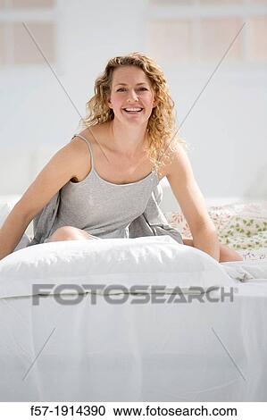 Attractive young woman in bed View Large Photo Image Stock Image - Attractive young woman in bed. Fotosearch