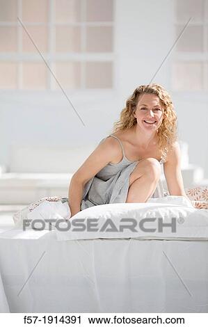 Attractive young woman in bed View Large Photo Image Stock Image - Attractive young woman in bed. Fotosearch