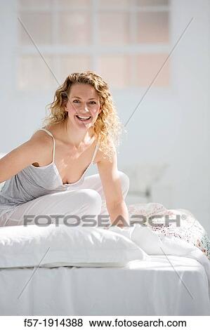 Attractive young woman in bed View Large Photo Image Stock Photo - Attractive young woman in bed. Fotosearch