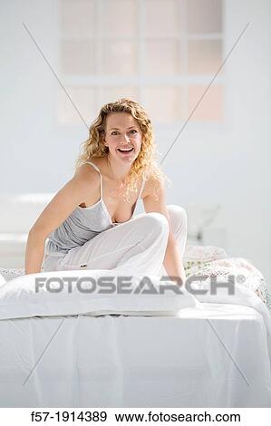 Attractive young woman in bed View Large Photo Image Stock Photo - Attractive young woman in bed. Fotosearch