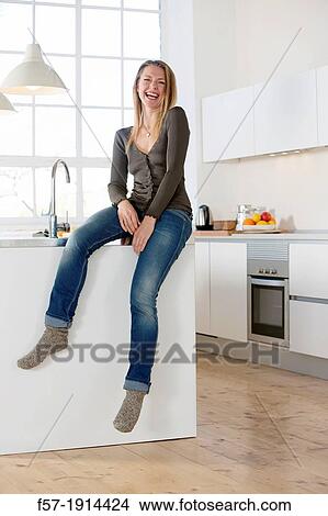 Attractive young woman in her kitchen View Large Photo Image Picture - Attractive young woman in her kitchen. Fotosearch