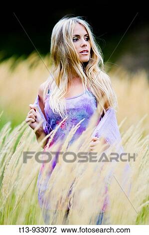 Stock Image - Attractive young woman in nature. Fotosearch
