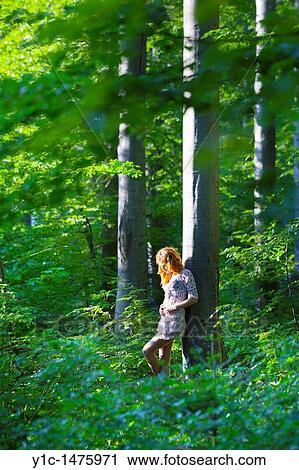 Stock Image - Attractive young woman in the woods -? forest angel?. Fotosearch