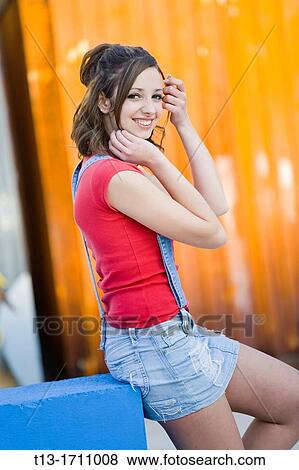 Attractive young woman is adjusting hair View Large Photo Image Stock Photo - Attractive young woman is adjusting hair. Fotosearch