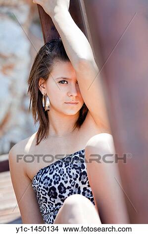 Attractive young woman is lying in a shadow and peeking on one eye View Large Photo Image Picture - Attractive young woman is lying in a shadow and peeking on one eye. Fotosearch
