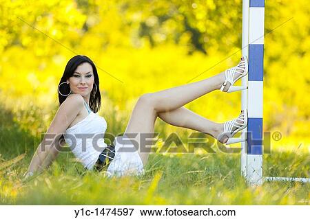 Stock Photo - Attractive young woman is posing on a goal line. Fotosearch