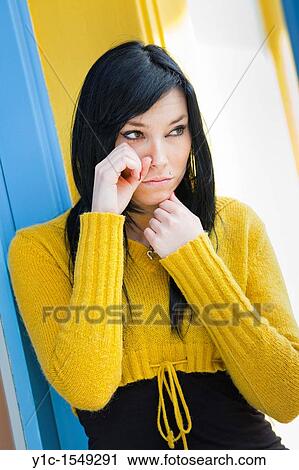 Stock Image - Attractive young woman is sad. Fotosearch