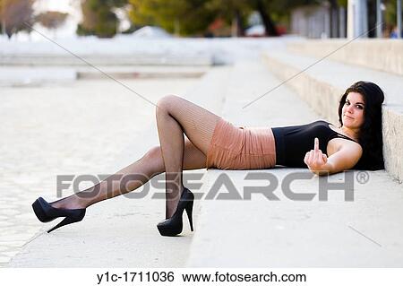 Attractive young woman is showing a middle finger View Large Photo Image Stock Photograph - Attractive young woman is showing a middle finger. Fotosearch
