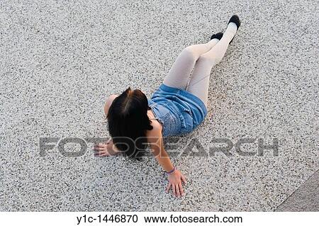 Attractive young woman is sitting on the floor, denim short dress and fashionable White thighs View Large Photo Image Stock Image - Attractive young woman is sitting on the floor, denim short dress and fashionable White thighs. Fotosearch
