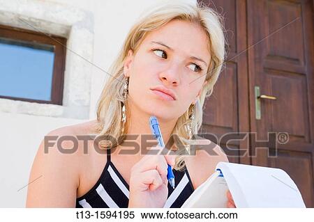 Attractive young woman is uncertain View Large Photo Image Stock Photography - Attractive young woman is uncertain. Fotosearch
