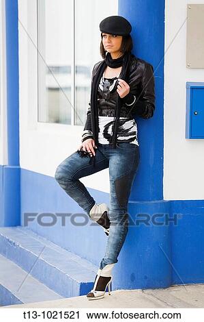 Attractive young woman is waiting on the corner of the Blue house View Large Photo Image Stock Image - Attractive young woman is waiting on the corner of the Blue house. Fotosearch