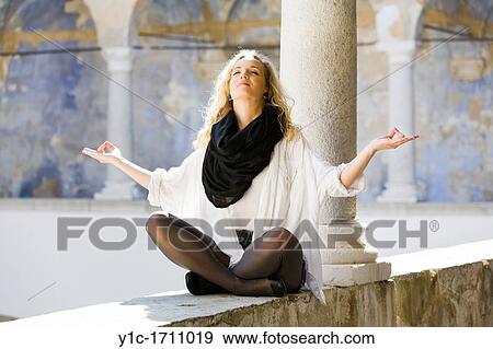 Stock Photo - Attractive young woman performing yoga. Fotosearch