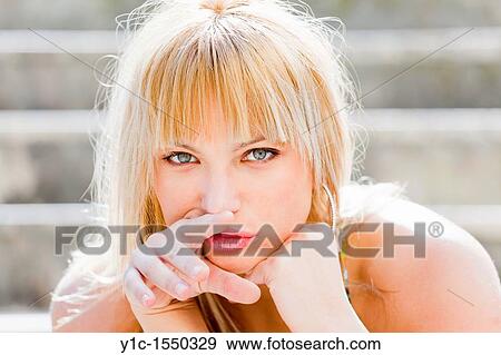 Stock Photo - Attractive young woman portrait acting greedy. Fotosearch