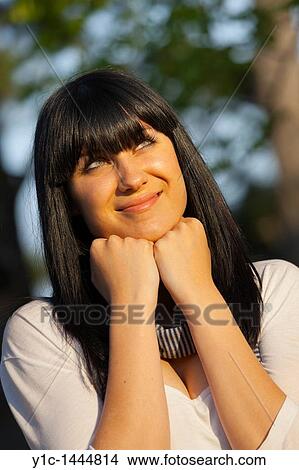 Picture - Attractive young woman portrait watching sunset. Fotosearch