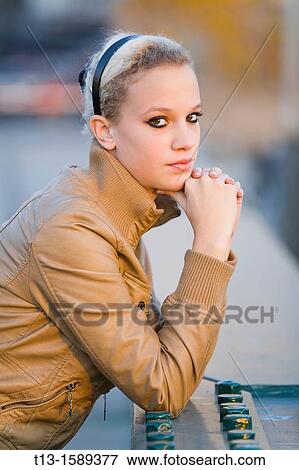 Stock Photo - Attractive young woman portrait, warm evening light. Fotosearch