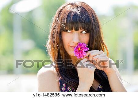 Attractive young woman portrait with a flower in hands View Large Photo Image Stock Photography - Attractive young woman portrait with a flower in hands. Fotosearch