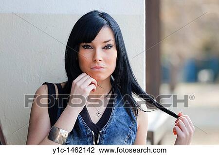 Attractive young woman pulling hair View Large Photo Image Stock Image - Attractive young woman pulling hair. Fotosearch