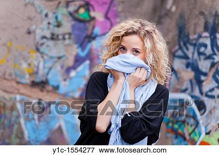 Attractive young woman shy and hiding face View Large Photo Image Stock Photo - Attractive young woman shy and hiding face. Fotosearch
