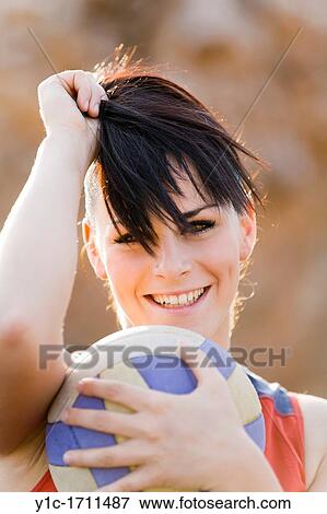 Stock Photo - Attractive young woman with a ball. Fotosearch