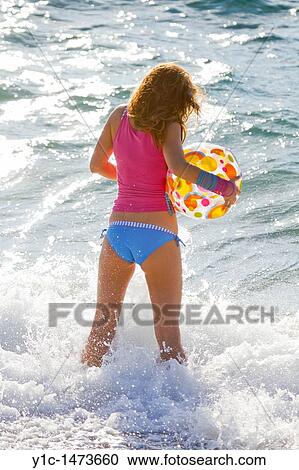 Attractive young woman with an inflatable ball on the beach View Large Photo Image Stock Image - Attractive young woman with an inflatable ball on the beach. Fotosearch