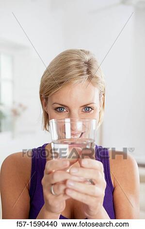 Attractive young woman with glass of water View Large Photo Image Stock Image - Attractive young woman with glass of water. Fotosearch