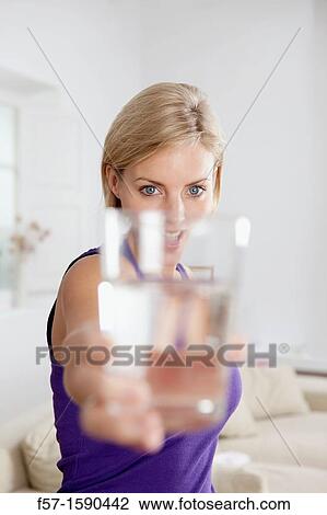Stock Image - Attractive young woman with glass of water. Fotosearch