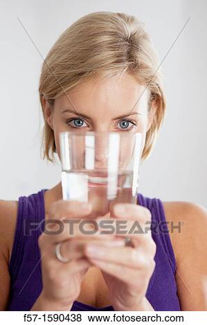 Stock Photo - Attractive young woman with glass of water. Fotosearch