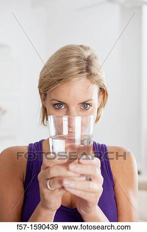 Attractive young woman with glass of water View Large Photo Image Stock Photo - Attractive young woman with glass of water. Fotosearch
