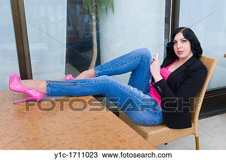 Attractive young woman with legs on a table View Large Photo Image Stock Image - Attractive young woman with legs on a table. Fotosearch