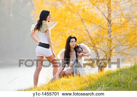 Stock Image - Attractive young women, acting nature angels. Fotosearch