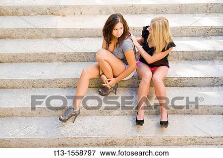 Attractive young women are sitting on steps View Large Photo Image Stock Photo - Attractive young women are sitting on steps. Fotosearch