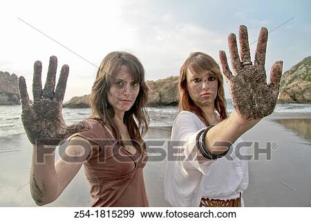 Attractives youngs Women on the beach, with sand in their faces and hands, El Sablon, Asturias, Spain View Large Photo Image Stock Photo - Attractives youngs Women on the beach, with sand in their faces and hands, El Sablon, Asturias, Spain. Fotosearch