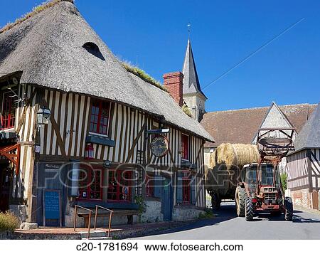 Auberge des deux tonneaux,? two barrels inn?, tyical ancient norman cottage, thatched and half timbered, with tractor, Pierrefitte en Auge, Calvados 14, Normandy, France View Large Photo Image Picture - Auberge des deux tonneaux,? two barrels inn?, tyical ancient norman cottage, thatched and half timbered, with tractor, Pierrefitte en Auge, Calvados 14, Normandy, France. Fotosearch