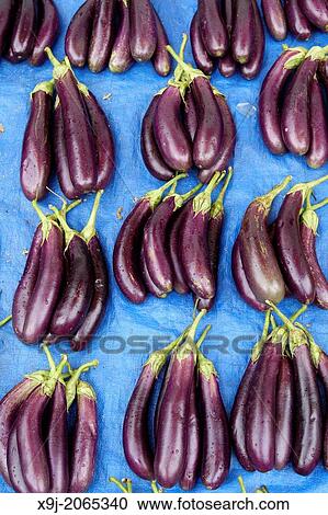 Stock Image - aubergine display in local market, asia. Fotosearch