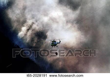 Stock Image - August 2013 Lugo Fire in Navia, in Ancares, Natura protected area, Biosphere and reserba. It affects more than 500 hectares of forest. Aerial and terrestrial media trying to control the fire from Thursday.. Fotosearch
