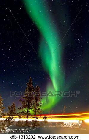 Stock Image - Aurora Borealis Northern Polar Lights over the boreal forest outside Yellowknife, Northwest Territories, Canada. Fotosearch