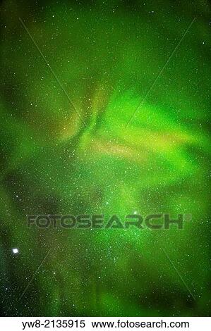 Stock Photography - Aurora Borealis or Northern Lights with Milky Way Galaxy, Lapland, Sweden. Cold temperatures as low as -47 celsius.. Fotosearch