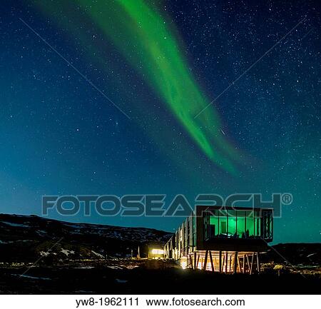 Stock Image - Aurora borealis over Hotel ION, located by Nesjavellir Power Plant, Iceland.. Fotosearch