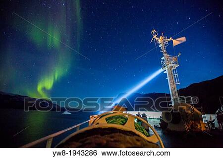 Stock Photograph - Aurora Borealis seen from a cruise ship, Scoresbysund, Greenland. The Akademik Sergey Vavilov-Russian research vessel built in 1988 currently used as a cruise ship.. Fotosearch