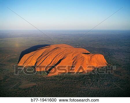 Australia, Northern Territory, Uluru-Kata Tjuta National Park, aerial view of Ayers Rock, the famous inselberg is a large arcose outcrop rising 348 metre above the surrounding plain. View Large Photo Image Stock Image - Australia, Northern Territory, Uluru-Kata Tjuta National Park, aerial view of Ayers Rock, the famous inselberg is a large arcose outcrop rising 348 metre above the surrounding plain.. Fotosearch