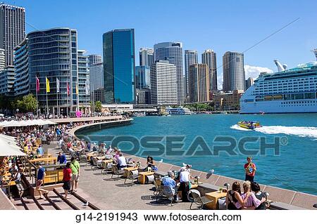 Australia, NSW, New South Wales, Sydney, Sydney Harbour, harbor, East Circular Quay, CBD, Central Business District, city skyline, skyscrapers, promenade, Opera Bar, restaurant, alfresco dining, tables, umbrellas, water. View Large Photo Image Stock Image - Australia, NSW, New South Wales, Sydney, Sydney Harbour, harbor, East Circular Quay, CBD, Central Business District, city skyline, skyscrapers, promenade, Opera Bar, restaurant, alfresco dining, tables, umbrellas, water.. Fotosearch
