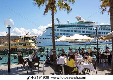 Australia, NSW, New South Wales, Sydney, Sydney Harbour, harbor, East Circular Quay, promenade, restaurant, alfresco dining, tables, umbrellas, cruise ship, port, Sydney Ferries, ferry, public transportation. View Large Photo Image Stock Photo - Australia, NSW, New South Wales, Sydney, Sydney Harbour, harbor, East Circular Quay, promenade, restaurant, alfresco dining, tables, umbrellas, cruise ship, port, Sydney Ferries, ferry, public transportation.. Fotosearch