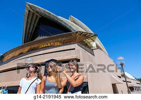 Australia, NSW, New South Wales, Sydney, Sydney Harbour, harbor, Sydney Opera House, design, shell, roof, woman, friends, taking picture, smartphone. View Large Photo Image Stock Photography - Australia, NSW, New South Wales, Sydney, Sydney Harbour, harbor, Sydney Opera House, design, shell, roof, woman, friends, taking picture, smartphone.. Fotosearch