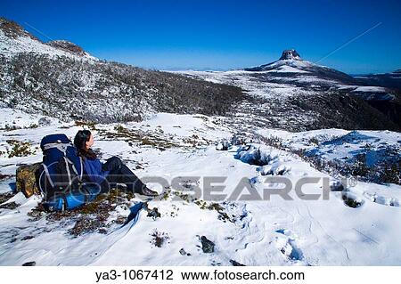 Australia, Tasmania, Cradle Mt - Lake St Clair National Park Hiker walking the overland track takes a rest to enjoy the scenery View Large Photo Image Stock Image - Australia, Tasmania, Cradle Mt - Lake St Clair National Park Hiker walking the overland track takes a rest to enjoy the scenery. Fotosearch