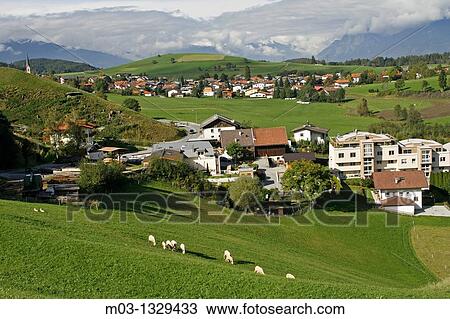 Stock Image - Austria Tirol Tyrol Rinn small town mountain high road pastoral landscape with sheep. Fotosearch