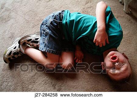 Autistic boy on floor View Large Photo Image Stock Photo - Autistic boy on floor. Fotosearch