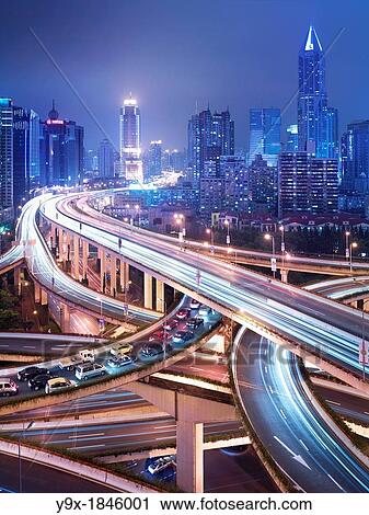 Stock Image - Automobiles in congested onramp traffic at a six-level stack interchange highway in Puxi, Shanghai, China. Fotosearch