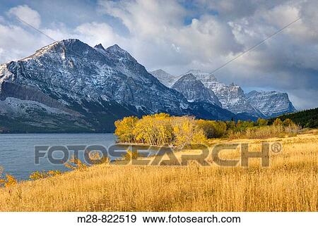 Autumn view along Lake McDonald, Glacier National Park Montana USA View Large Photo Image Stock Photo - Autumn view along Lake McDonald, Glacier National Park Montana USA. Fotosearch